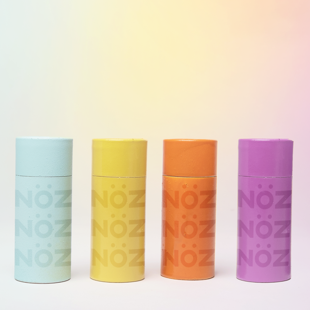 Neon blue, yellow, orange, and purple nose sunscreen containers