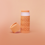 Load image into Gallery viewer, Opened light orange nose sunscreen container in modern orange biodegradable packaging
