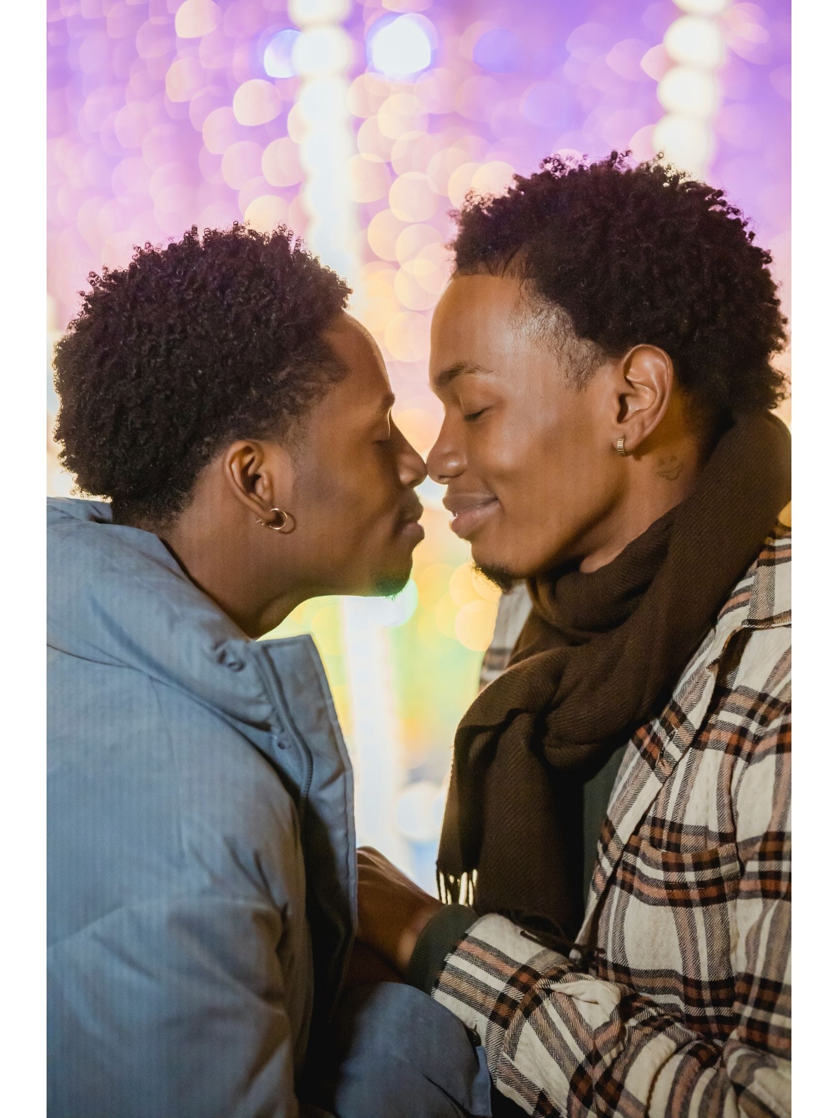 Young black gay couple giving each other butterfly kisses